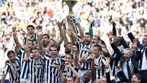 TURIN, ITALY - MAY 18:  The Juventus FC players celebrate with the Serie A trophy at the end of the Serie A match between Juventus and Cagliari Calcio at Juventus Arena on May 18, 2014 in Turin, Italy.  (Photo by Valerio Pennicino/Getty Images)